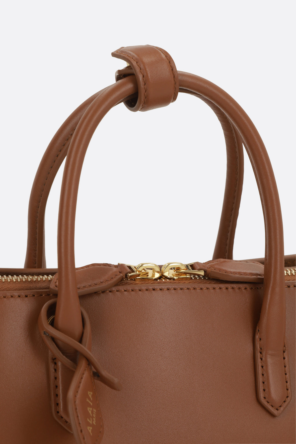 Alaia Women's Top Handle Bag in Ambra